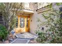 Inviting front entrance with a custom wood door and tiled roof and professionally monitored security system at 5180 N Dapple Gray Rd, Las Vegas, NV 89149