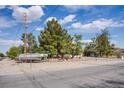 Street view of home with desert landscaping and a parked boat at 5180 N Dapple Gray Rd, Las Vegas, NV 89149