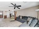 Comfortable living room featuring neutral tile flooring and an overhead ceiling fan at 5228 Fire Night Ave, Las Vegas, NV 89122