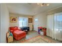 Inviting living room with red armchair, decorative rug, and window, creating a warm atmosphere at 533 Date St, Boulder City, NV 89005