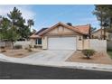 Single-story home features a two-car garage, desert landscaping, terracotta roof, and solar panels at 5638 Morning Song Cir, North Las Vegas, NV 89031
