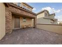 Private courtyard with a stone pillar-supported roof and seating area at 595 Beverly Pine Pl, Henderson, NV 89011
