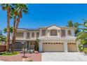Attractive two-story home featuring a three-car garage, desert landscaping and solar panels on the roof at 7141 Groveton Ct, Las Vegas, NV 89131
