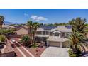 Gorgeous two-story home featuring a three-car garage, desert landscaping and solar panels on the roof at 7141 Groveton Ct, Las Vegas, NV 89131