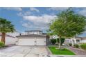 Charming stucco home featuring a three-car garage, desert landscaping, and covered front entry at 760 Camino La Paz, Henderson, NV 89012