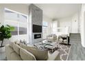 Bright living room features a stone fireplace, modern fixtures and finishes at 760 Camino La Paz, Henderson, NV 89012