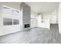 Bright living room features a stone fireplace, modern fixtures and finishes at 760 Camino La Paz, Henderson, NV 89012