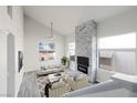 Bright living room features a stone fireplace, modern fixtures and finishes at 760 Camino La Paz, Henderson, NV 89012