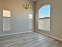Bright living room featuring tall ceilings, transom windows and contemporary gray flooring at 8717 Harvest Valley Ave, Las Vegas, NV 89129