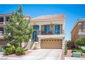 Charming two-story home with a balcony, a two-car garage, and drought tolerant desert landscaping at 9450 Niagara Landing St, Las Vegas, NV 89139