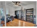 Bright home office featuring built-in shelves and hardwood flooring at 10213 Treasure Mountain Ct, Las Vegas, NV 89129