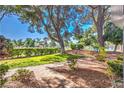 Landscaped path with mature trees and green space provides a scenic approach to this charming neighborhood at 1030 Tam O Shanter, Las Vegas, NV 89109