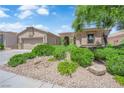 Charming single-story home with desert landscaping, stone accents, and a two-car garage at 10372 Premia Pl, Las Vegas, NV 89135