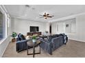 Bright living room with tile floors, modern furnishings, a fireplace, and neutral color palette at 10372 Premia Pl, Las Vegas, NV 89135