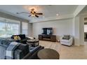 Comfortable living room with tile floors, recessed lighting, ceiling fan, and media center at 10372 Premia Pl, Las Vegas, NV 89135