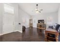 Bright living room with high ceilings, dark hardwood floors and ample natural light at 1084 Little House Ct, Henderson, NV 89011
