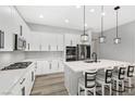 Bright kitchen featuring white cabinets, modern appliances, a gas range, and an island with bar seating at 10968 Tracy Stevens Ave, Las Vegas, NV 89166
