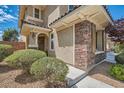Inviting home exterior featuring stone accents, a covered entry, and well-maintained landscaping for added curb appeal at 1113 Via Della Costrella, Henderson, NV 89011