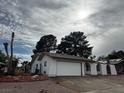 Charming single-story home featuring a two-car garage, arched windows, and xeriscaping under a cloudy sky at 1126 Azul Way, Boulder City, NV 89005