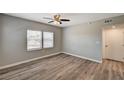 Bright bedroom with wood-look flooring, ceiling fan, and neutral color palette at 155 Magnesium St, Henderson, NV 89015
