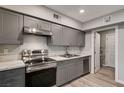 Functional kitchen featuring gray cabinets, stainless steel appliances and lots of storage at 155 Magnesium St, Henderson, NV 89015