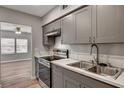 Well-lit kitchen with gray cabinets, stainless steel appliances, and durable countertops at 155 Magnesium St, Henderson, NV 89015