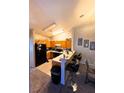 Well-lit kitchen featuring wood cabinets, a breakfast bar and a range of appliances at 1612 Lefty Garcia Way, Henderson, NV 89002