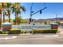 Sun City MacDonald Ranch Community Center entrance sign surrounded by lush landscaping and palm trees at 2105 Poppywood Ave, Henderson, NV 89012