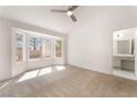 Bright bedroom featuring a cozy sitting area near a bay window and ensuite bathroom access at 2520 Springridge Dr, Las Vegas, NV 89134