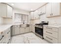 Renovated kitchen showcasing new cabinets, stainless steel appliances, farmhouse sink, and marble countertops at 2520 Springridge Dr, Las Vegas, NV 89134