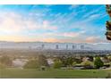 Panoramic city view featuring iconic landmarks, lush greenery, and a stunning sky at 2742 Darby Falls Dr, Las Vegas, NV 89134