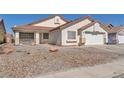 Inviting single-story home with desert landscaping, covered front porch, and attached garage at 2753 Trickling Brook Ct, Las Vegas, NV 89156