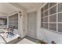 Close-up of a welcoming front porch with a security gate and outdoor seating at 2753 Trickling Brook Ct, Las Vegas, NV 89156