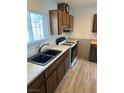 Close-up of a kitchen with dark cabinets, a white stove, and tiled backsplash at 2804 E Gowan Rd, North Las Vegas, NV 89030