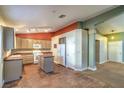 Spacious kitchen with light wood cabinetry, appliances, and center island with tile floors at 2809 Mountain Violet Ct, Las Vegas, NV 89108
