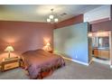 Comfortable primary bedroom features a large bed and ensuite bathroom at 2809 Mountain Violet Ct, Las Vegas, NV 89108