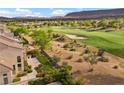 Backyard with a manicured lawn, desert landscape, and a view of the lush green golf course beyond the property at 2933 Red Springs Dr, Las Vegas, NV 89135