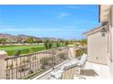 A covered balcony offers scenic views of the golf course and mountains, along with comfortable seating at 2933 Red Springs Dr, Las Vegas, NV 89135