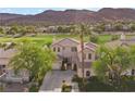 Stately two-story home with meticulously kept landscaping, circular driveway, and a palm tree in front at 2933 Red Springs Dr, Las Vegas, NV 89135