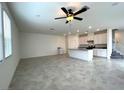 Open-concept living room with a kitchen, tile flooring and ample natural light at 2970 Saltillo Ln, Las Vegas, NV 89121