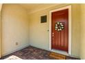 Inviting front entry featuring a charming red door, a decorative wreath, and a 