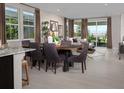 Open concept living area with large windows, neutral decor, and a dining area at 3430 Oristano Ln, Henderson, NV 89044