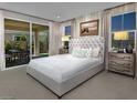 Serene primary bedroom with a sliding glass door, natural light, and neutral tones at 3430 Oristano Ln, Henderson, NV 89044