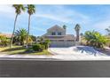 Charming two-story home with a three-car garage and well-maintained landscaping with palm trees at 356 Clark Dr, Henderson, NV 89074