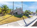 Well-manicured front yard with palm trees, and a two-story home with a driveway at 356 Clark Dr, Henderson, NV 89074
