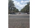 Gated community entrance with lush trees on either side of the road at 3987 Saddlewood Ct, Las Vegas, NV 89121