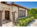 Close up of front door with slate porch and desert landscaping at 3987 Saddlewood Ct, Las Vegas, NV 89121