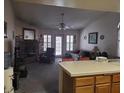 Spacious living room features high ceilings, a ceiling fan, and a fireplace at 3987 Saddlewood Ct, Las Vegas, NV 89121