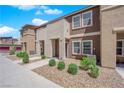 Charming townhome showcasing a well-kept exterior with gravel landscaping and healthy bushes at 471 Secret Cove Ct, Henderson, NV 89002