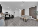 Bright, open-concept living space with stylish gray laminate flooring and modern accents at 471 Secret Cove Ct, Henderson, NV 89002